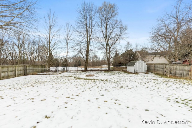 yard covered in snow featuring a shed