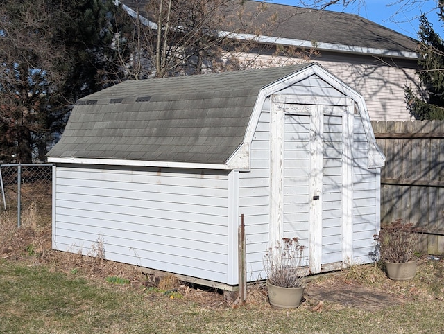 view of shed featuring fence