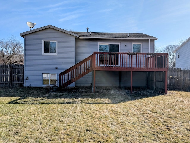 rear view of property with a wooden deck, stairs, a yard, and fence