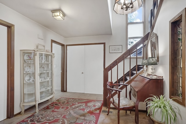 entrance foyer featuring a chandelier and light tile patterned flooring