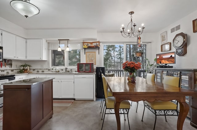 kitchen with white cabinetry, appliances with stainless steel finishes, sink, and pendant lighting