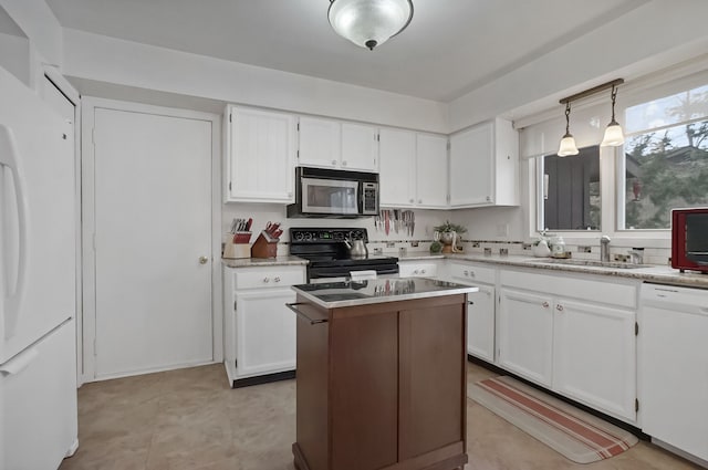 kitchen with pendant lighting, sink, white appliances, white cabinetry, and a center island