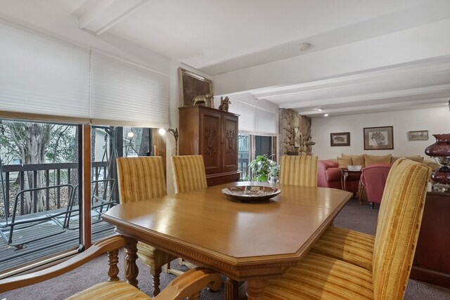 dining room featuring beam ceiling and carpet flooring