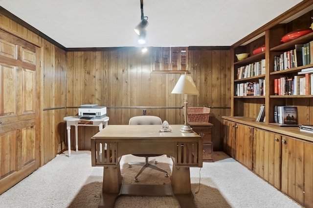 home office with light colored carpet and wood walls