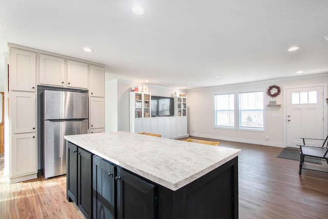 16715 Williamsville St, Vandalia, MI 49095 - kitchen featuring stainless steel refrigerator, a center island, and light hardwood / wood-style flooring