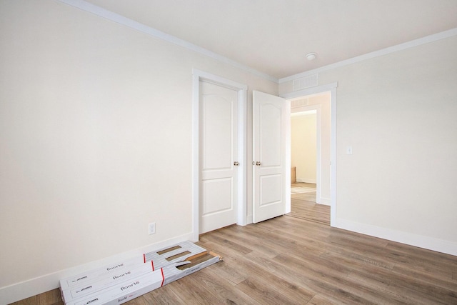 16715 Williamsville St, Vandalia, MI 49095 - unfurnished bedroom featuring crown molding and light hardwood / wood-style floors