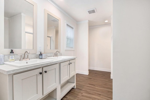16715 Williamsville St, Vandalia, MI 49095 - bathroom with hardwood / wood-style flooring, vanity, and crown molding