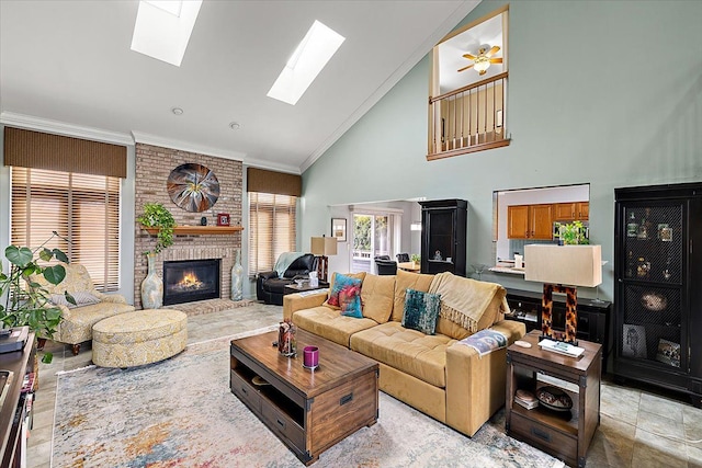 living room featuring a skylight, crown molding, a fireplace, and high vaulted ceiling