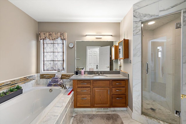 bathroom featuring vanity and separate shower and tub