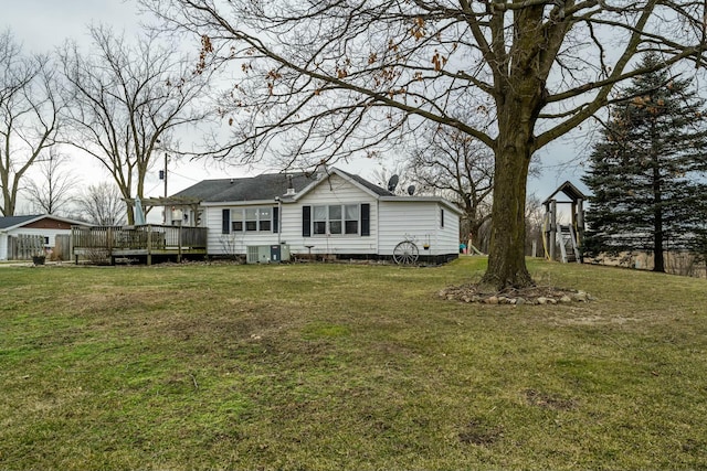 back of house with cooling unit, a lawn, and a deck