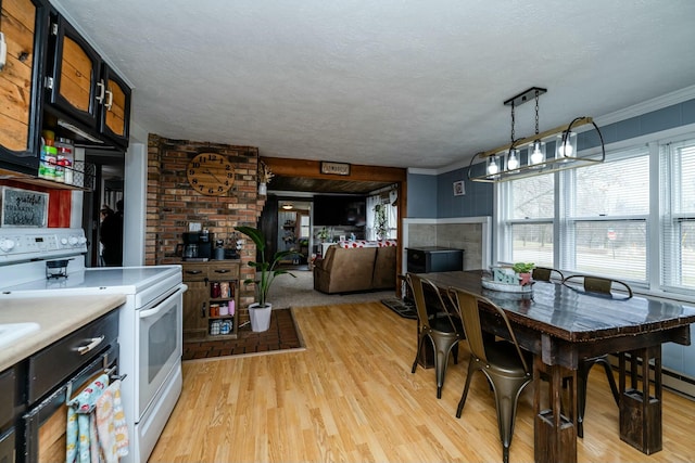 dining room featuring ornamental molding, a textured ceiling, and light hardwood / wood-style flooring