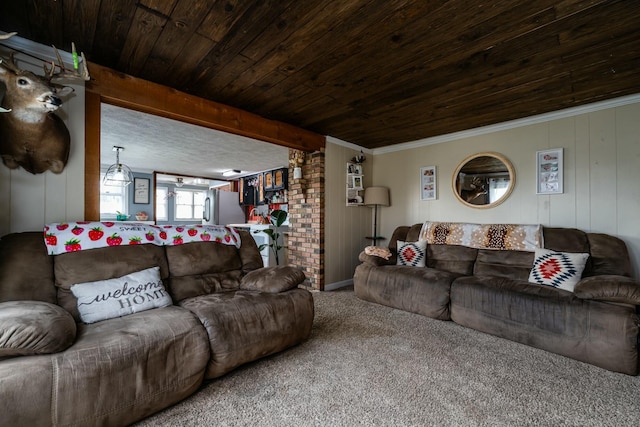 carpeted living room with beamed ceiling, ornamental molding, and wooden ceiling