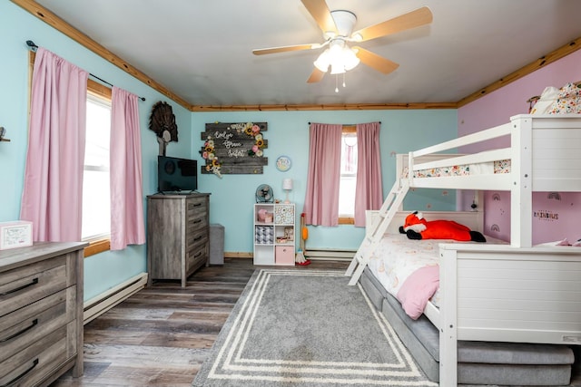 bedroom with ceiling fan, dark hardwood / wood-style flooring, and a baseboard heating unit