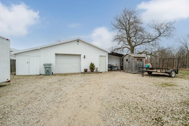 view of home's exterior with a garage and a shed