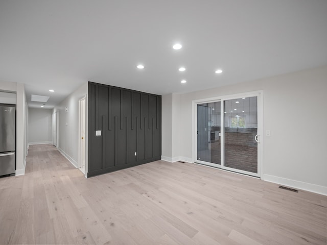 spare room with light hardwood / wood-style floors