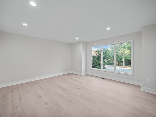 spare room with light hardwood / wood-style flooring