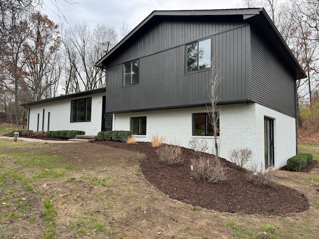 rear view of house featuring a yard