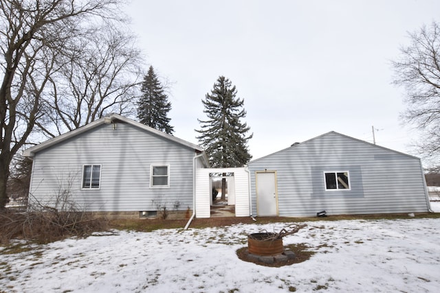 view of snow covered rear of property