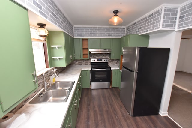 kitchen featuring brick wall, appliances with stainless steel finishes, sink, green cabinets, and dark wood-type flooring