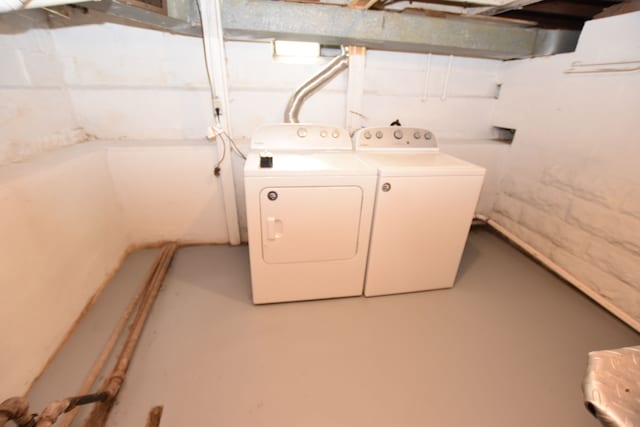 clothes washing area featuring separate washer and dryer