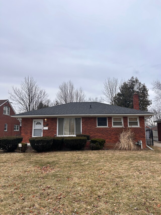 ranch-style home with a front lawn