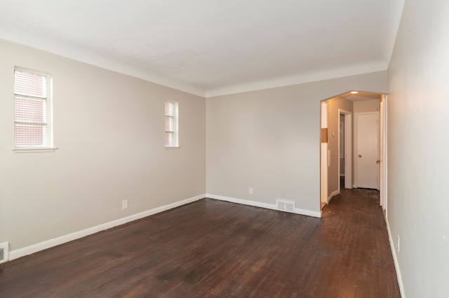 unfurnished room with dark hardwood / wood-style flooring