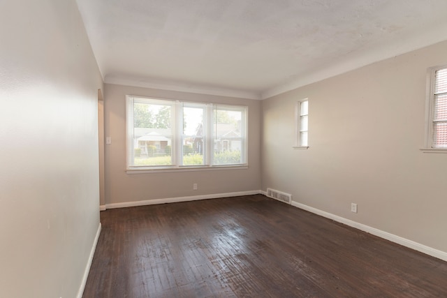 unfurnished room featuring plenty of natural light and dark hardwood / wood-style floors