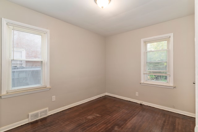 spare room with dark hardwood / wood-style floors