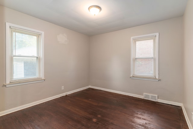 spare room featuring dark hardwood / wood-style floors