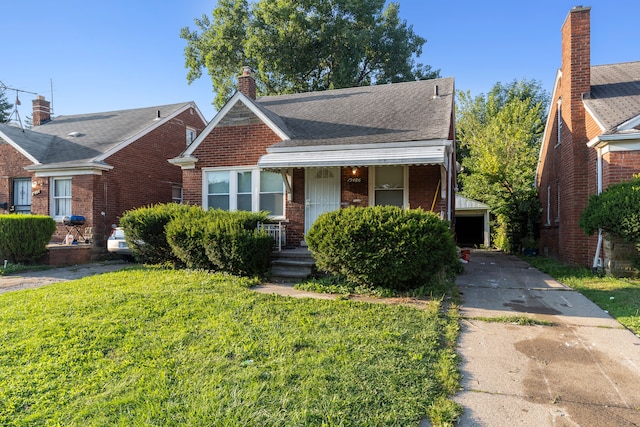 bungalow with a front yard and covered porch