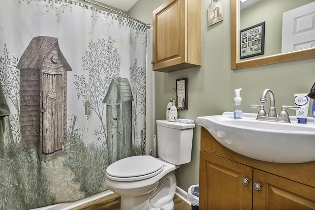 bathroom featuring hardwood / wood-style flooring, vanity, and toilet