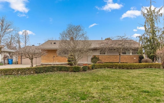 view of front of home with a garage and a front yard