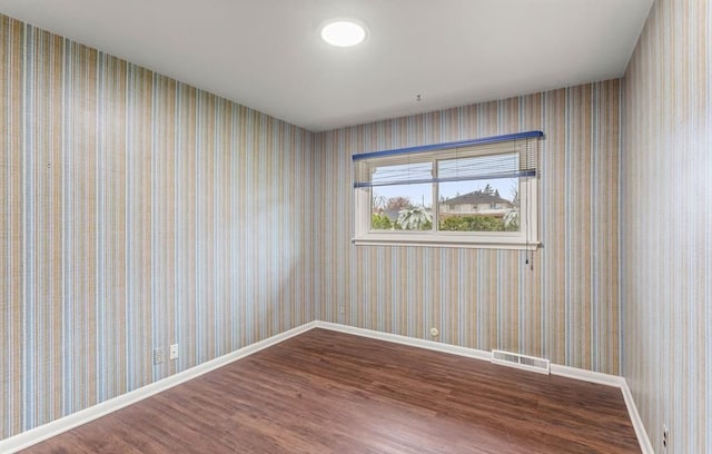 spare room featuring wood-type flooring