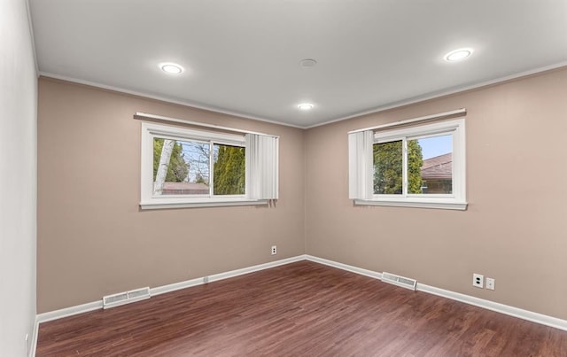 unfurnished room featuring crown molding and dark hardwood / wood-style floors