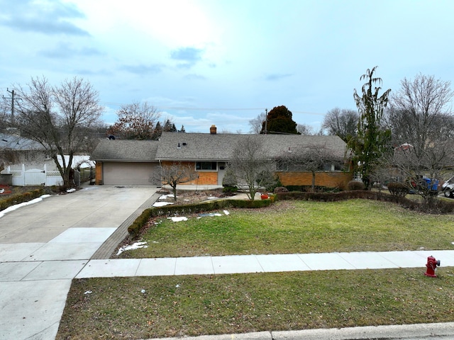 view of front of house with a garage and a front lawn