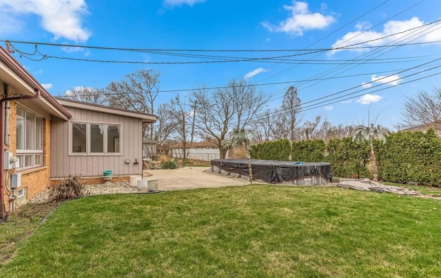 view of yard featuring a patio and a covered pool