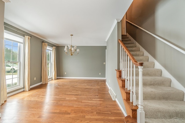 interior space featuring baseboards, ornamental molding, and wood finished floors