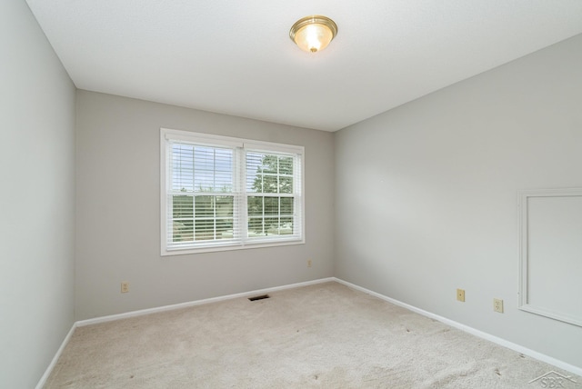 unfurnished room featuring carpet and baseboards