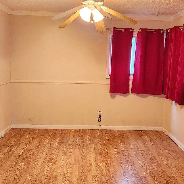 empty room featuring crown molding, ceiling fan, light hardwood / wood-style flooring, and a textured ceiling