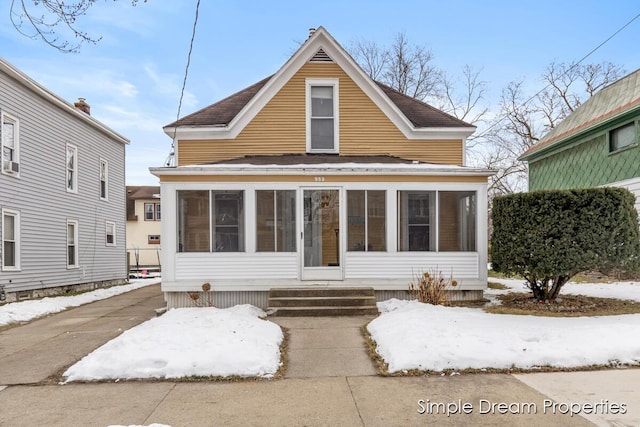 view of front of home with a sunroom