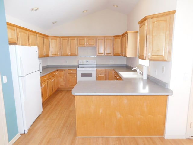 kitchen with white appliances, sink, light brown cabinets, and light wood-type flooring