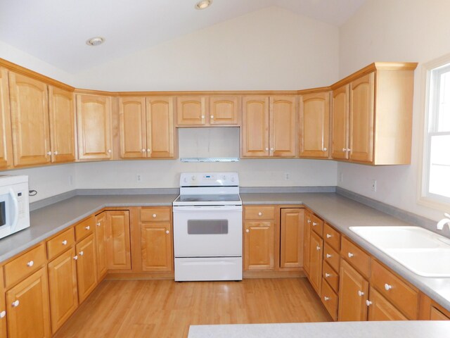 kitchen featuring lofted ceiling, sink, white appliances, and light hardwood / wood-style flooring