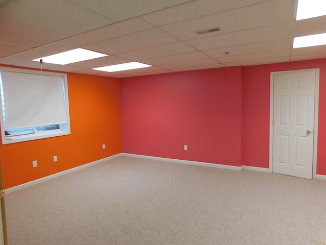 unfurnished room featuring carpet floors and a drop ceiling