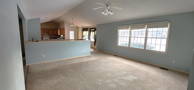 unfurnished living room featuring lofted ceiling, light carpet, and ceiling fan