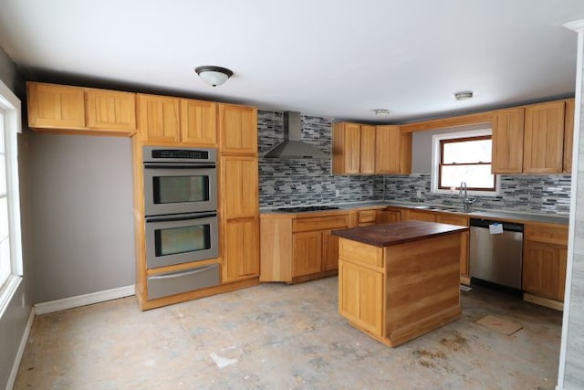 kitchen featuring decorative backsplash, dark countertops, wall chimney exhaust hood, appliances with stainless steel finishes, and a warming drawer