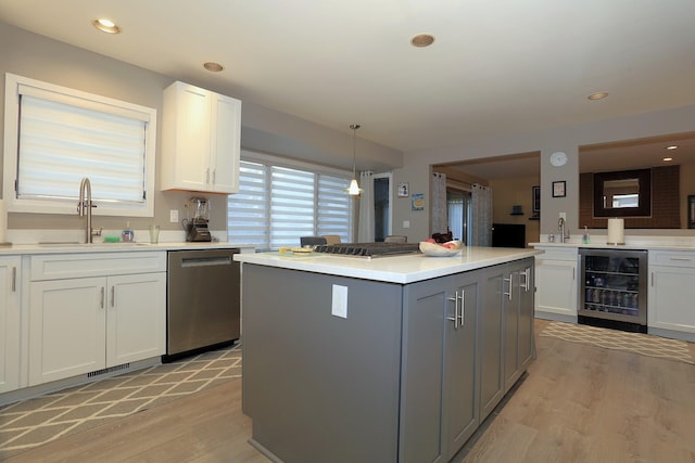 kitchen with gray cabinets, sink, white cabinets, wine cooler, and stainless steel dishwasher