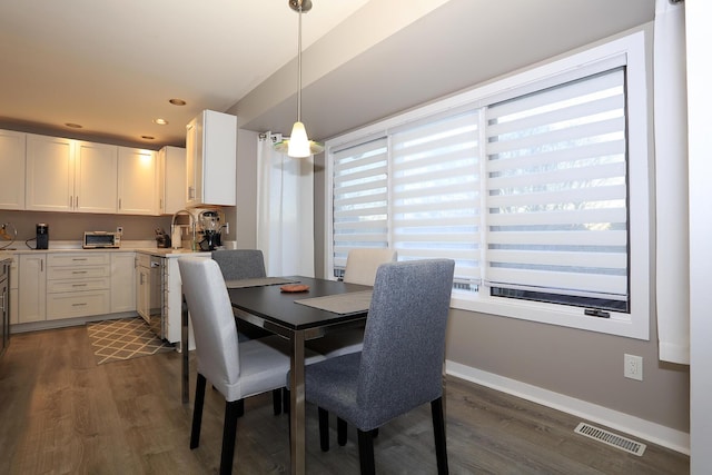 dining space featuring dark hardwood / wood-style flooring and sink