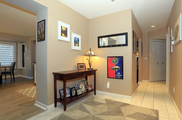 hall with light tile patterned floors