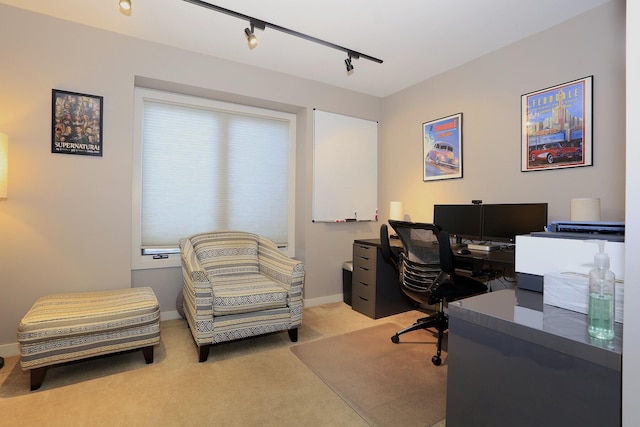 carpeted home office featuring rail lighting