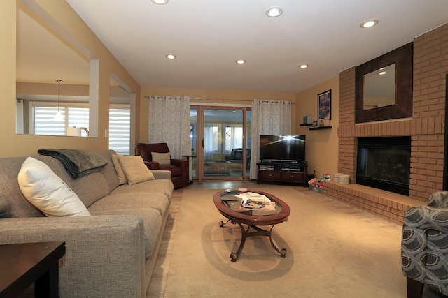 living room featuring a brick fireplace and plenty of natural light